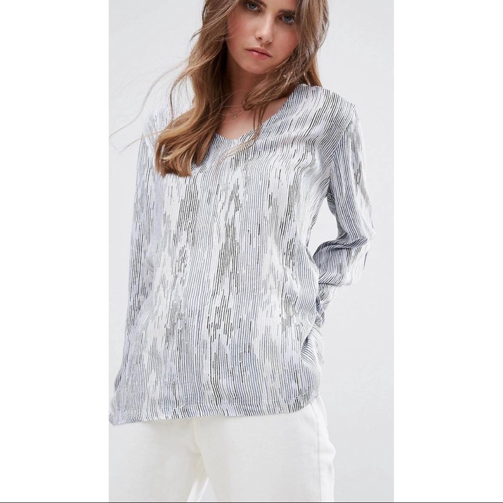 White V-neck shirt with blue, black and gray lines